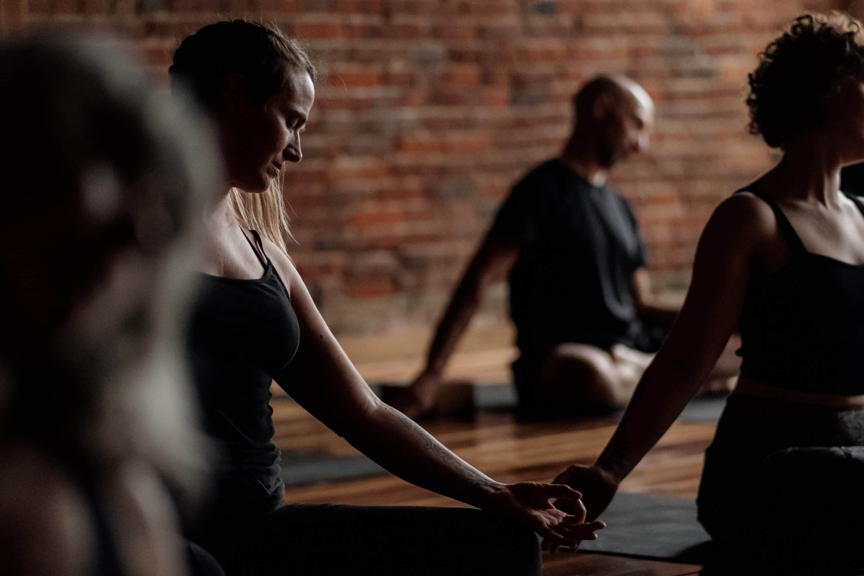 Modular Yoga Teacher Training Program Group of people in a seated yoga position during a modular yoga teacher training program.